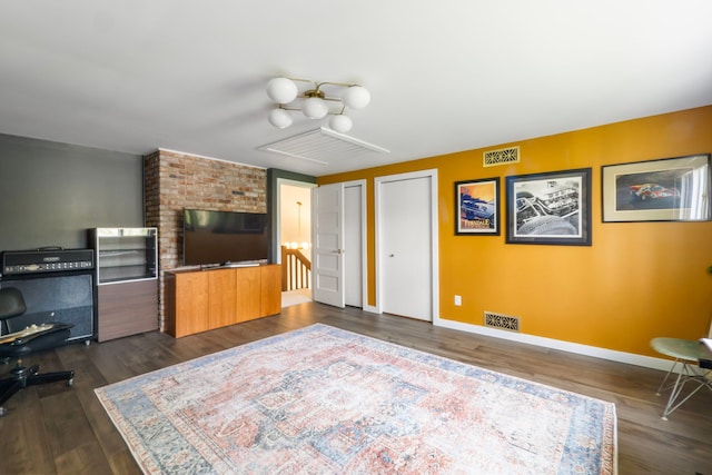 interior space with baseboards, visible vents, and dark wood-style floors