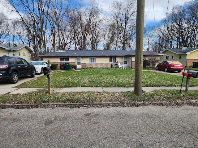 908/910 Pierce Rd, Lansing, MI 48910 - view of front facade with brick siding, driveway, and a front lawn