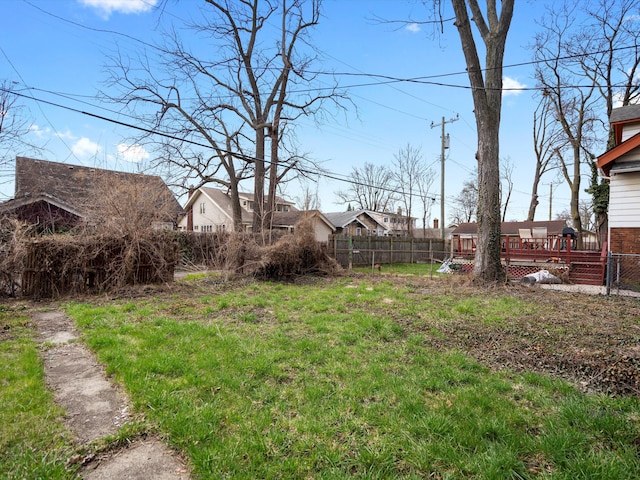 view of yard featuring a deck and fence
