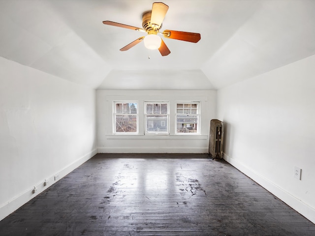 bonus room featuring ceiling fan, baseboards, dark wood finished floors, and lofted ceiling