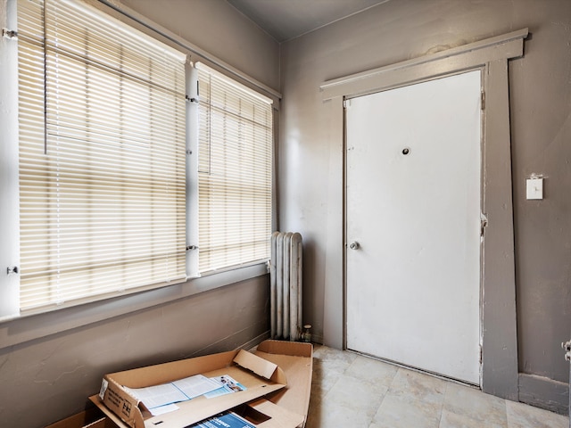 foyer entrance featuring radiator heating unit