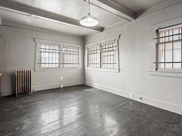 spare room with beam ceiling, a wealth of natural light, radiator, and baseboards