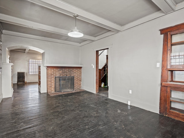 unfurnished living room featuring beam ceiling, baseboards, wood finished floors, and a fireplace