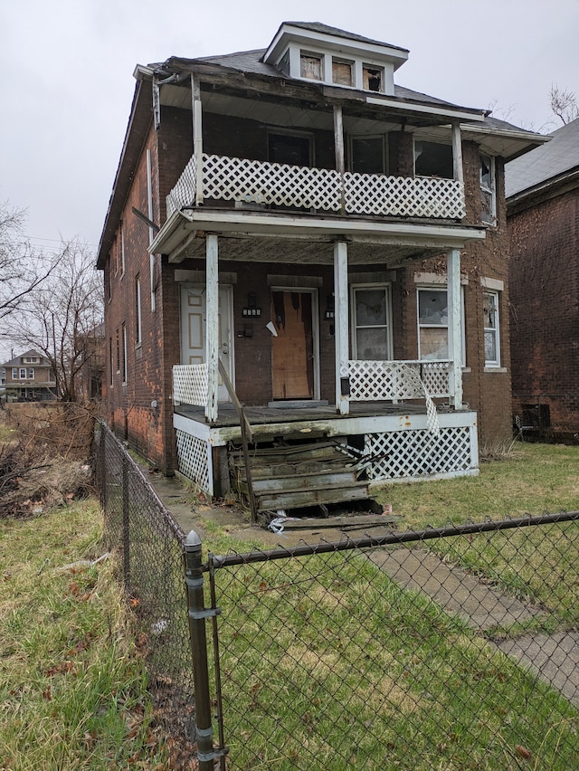 3749 Whitney, Detroit, MI 48206 - view of front of property with a fenced front yard, a porch, brick siding, a front yard, and a balcony