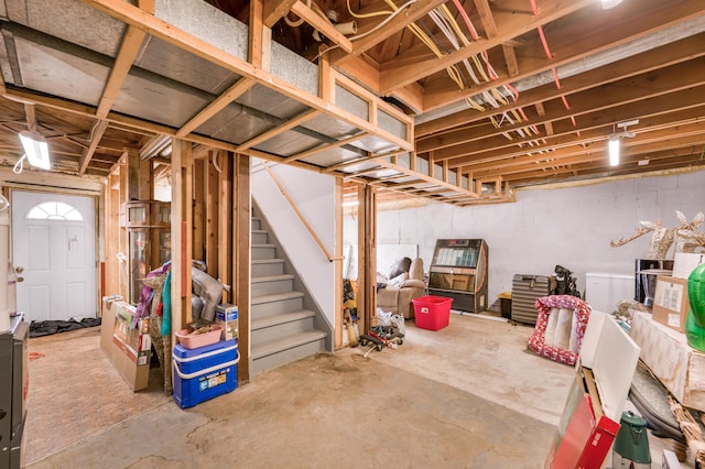 unfinished basement featuring stairs