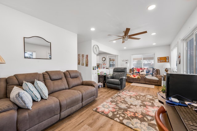 living room featuring recessed lighting, light wood-style flooring, and a ceiling fan