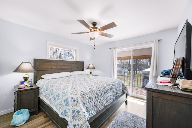 bedroom featuring wood finished floors, access to exterior, a ceiling fan, and baseboards