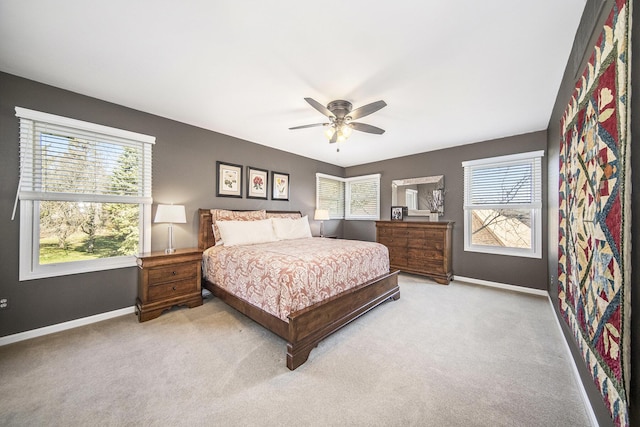 carpeted bedroom featuring baseboards and a ceiling fan