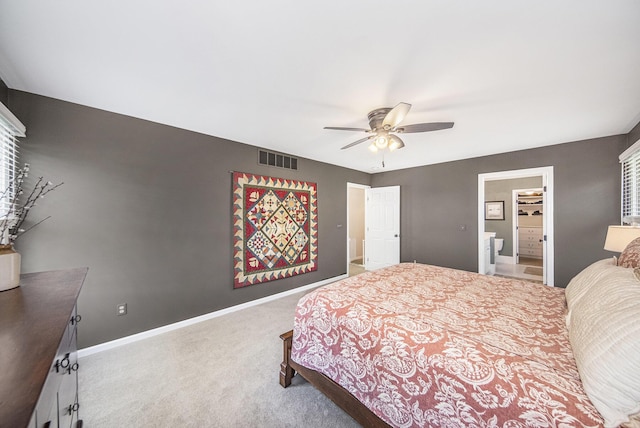 carpeted bedroom featuring visible vents, baseboards, ceiling fan, and connected bathroom