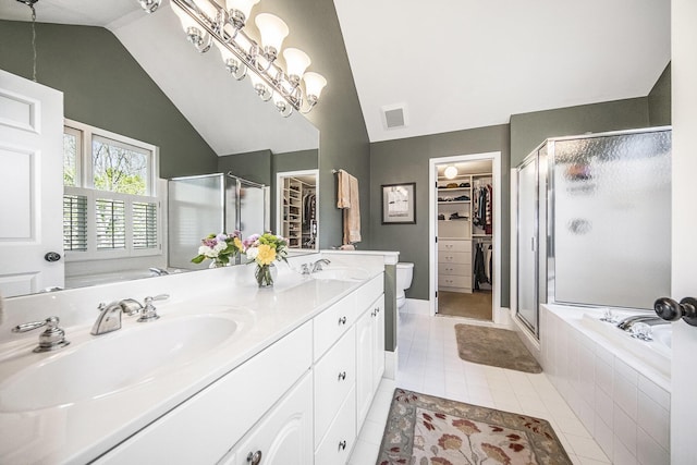 bathroom featuring a sink, a shower stall, visible vents, lofted ceiling, and a garden tub