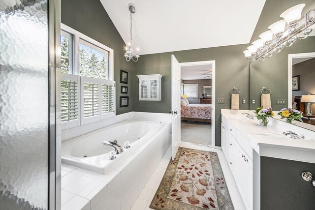 bathroom featuring an inviting chandelier, a tub with jets, ensuite bath, vaulted ceiling, and tile patterned flooring