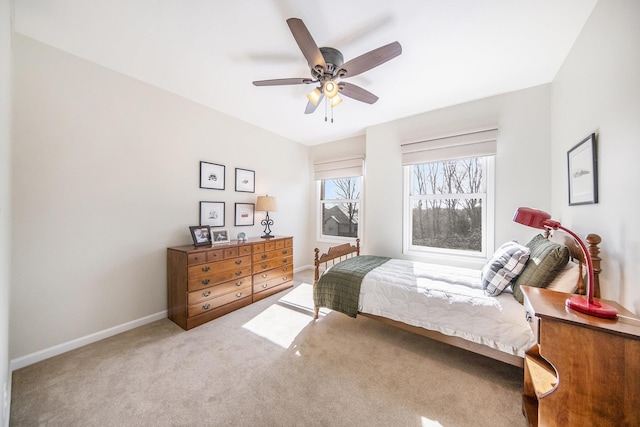 carpeted bedroom with baseboards and a ceiling fan