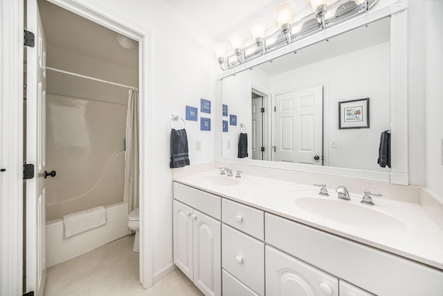 bathroom featuring double vanity, shower / bath combination with curtain, a sink, and toilet