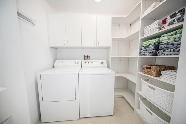 laundry area with washer and clothes dryer and cabinet space