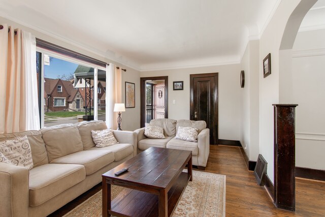 16890 Monica St, Detroit, MI 48221 - living room featuring crown molding, baseboards, arched walkways, and dark wood-style floors