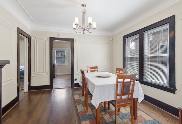 16890 Monica St, Detroit, MI 48221 - dining area featuring crown molding, baseboards, a chandelier, and dark wood-style floors