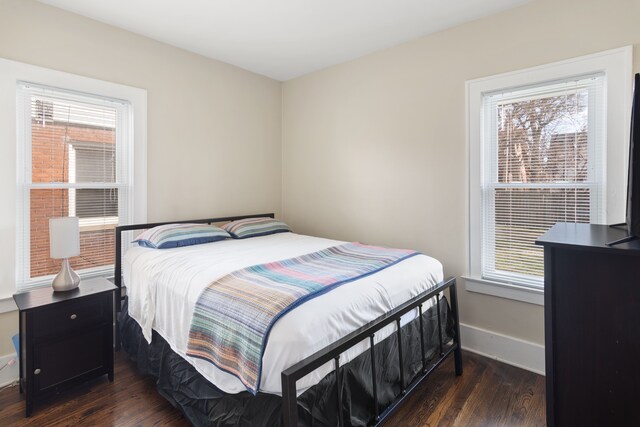16890 Monica St, Detroit, MI 48221 - bedroom with dark wood-style flooring, multiple windows, and baseboards