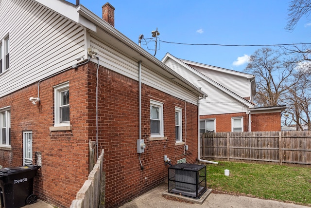 16890 Monica St, Detroit, MI 48221 - view of side of property with brick siding, fence, and a chimney