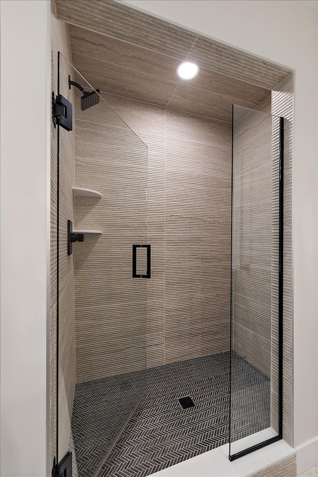 bathroom with a shower stall and recessed lighting