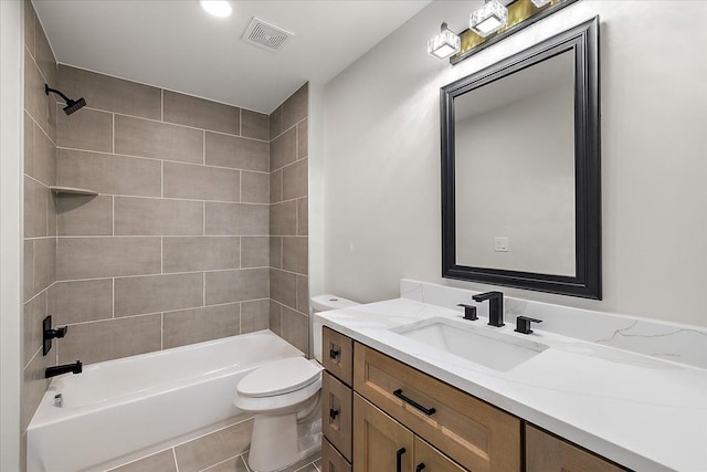 bathroom featuring visible vents, shower / washtub combination, toilet, vanity, and tile patterned floors