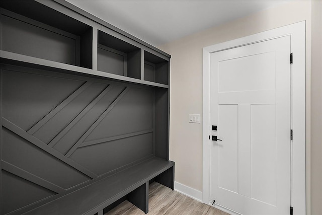 mudroom featuring baseboards and light wood finished floors