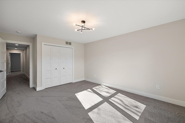 unfurnished bedroom featuring carpet, visible vents, and baseboards