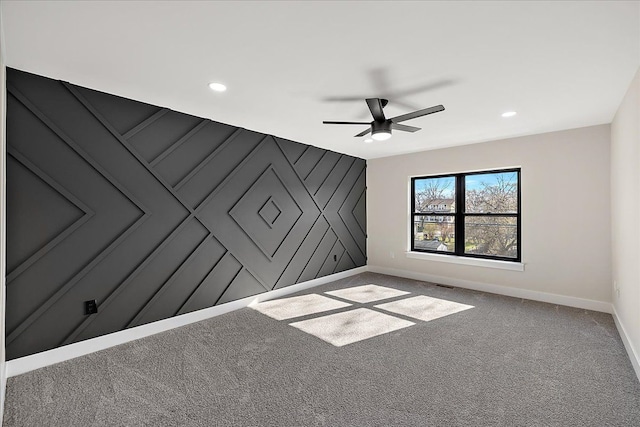 carpeted spare room with visible vents, baseboards, a ceiling fan, and recessed lighting
