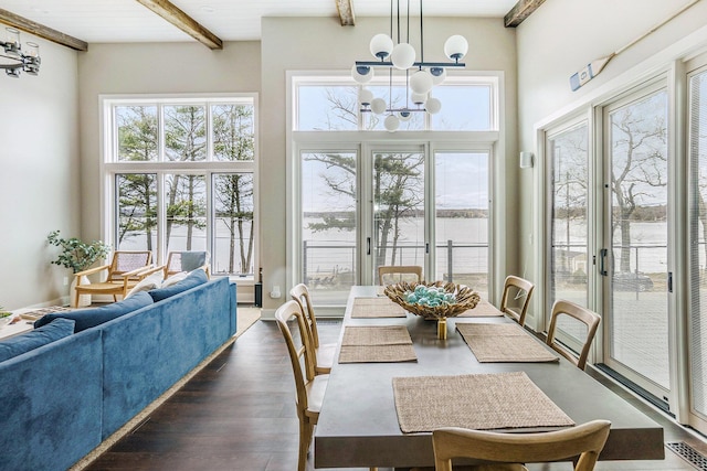 sunroom / solarium with beamed ceiling, visible vents, and an inviting chandelier