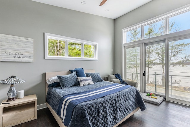bedroom with visible vents, access to exterior, multiple windows, and wood finished floors