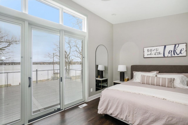 bedroom featuring visible vents, access to exterior, baseboards, and dark wood-style floors
