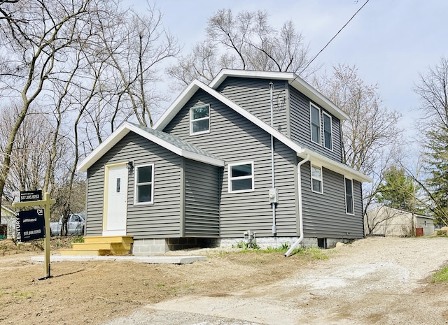 view of side of home with entry steps