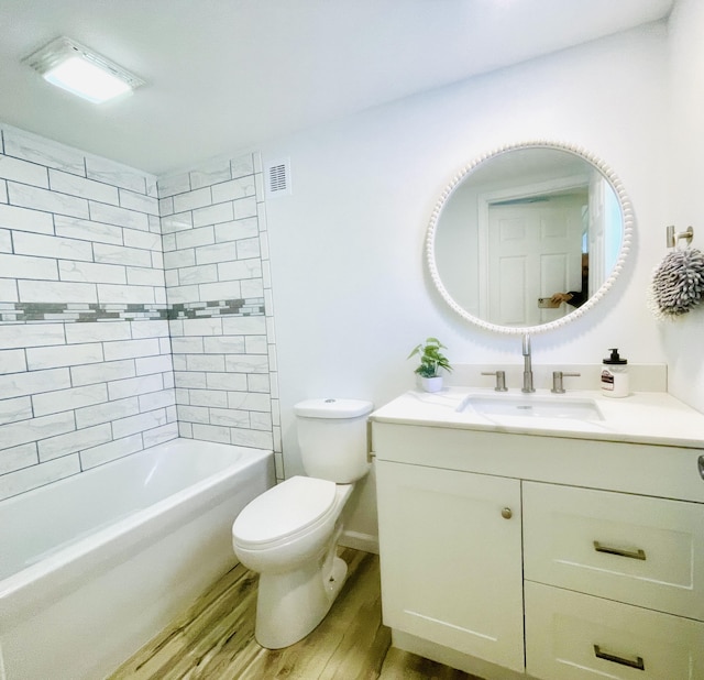 bathroom featuring vanity, visible vents, toilet, and wood finished floors