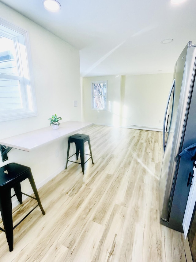 interior space with light wood-type flooring and baseboards