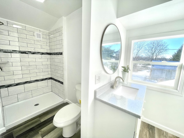 bathroom featuring visible vents, toilet, a shower stall, vanity, and wood finished floors