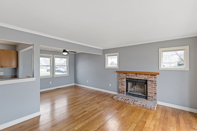 1053 Woodward Hts, Ferndale, MI 48220 - unfurnished living room with light wood-type flooring, baseboards, ornamental molding, and a brick fireplace