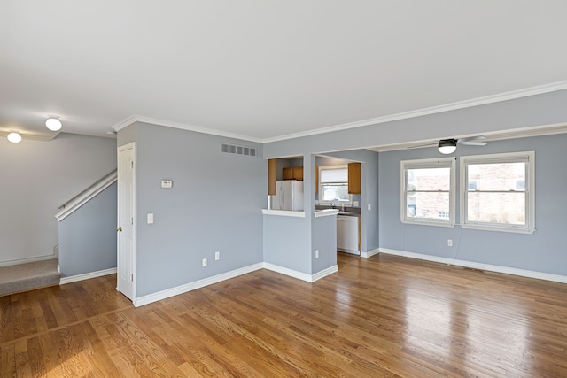 1053 Woodward Hts, Ferndale, MI 48220 - unfurnished living room with baseboards, ornamental molding, stairs, visible vents, and wood finished floors