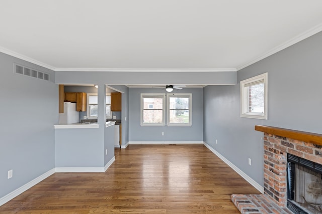 1053 Woodward Hts, Ferndale, MI 48220 - unfurnished living room featuring ceiling fan, a fireplace, visible vents, wood finished floors, and baseboards