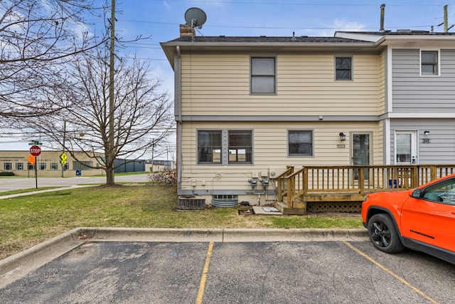 1053 Woodward Hts, Ferndale, MI 48220 - rear view of property featuring a yard, uncovered parking, a wooden deck, and a chimney