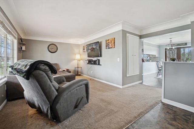 739 Gasper St, Chesaning, MI 48616 - carpeted living room with crown molding, a notable chandelier, and baseboards