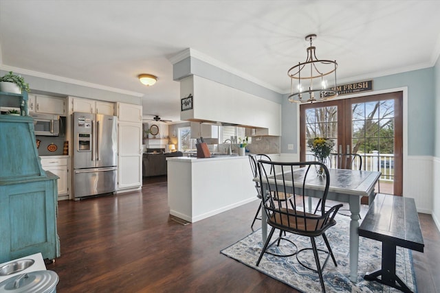 739 Gasper St, Chesaning, MI 48616 - dining space featuring crown molding, an inviting chandelier, and dark wood finished floors