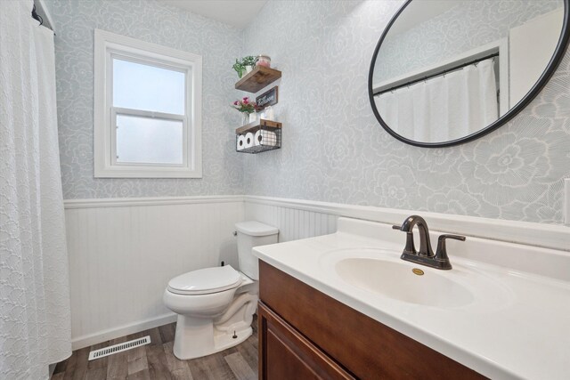739 Gasper St, Chesaning, MI 48616 - full bath with wallpapered walls, wood finished floors, wainscoting, and visible vents
