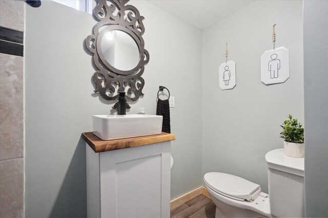 739 Gasper St, Chesaning, MI 48616 - half bath featuring toilet, wood finished floors, and vanity