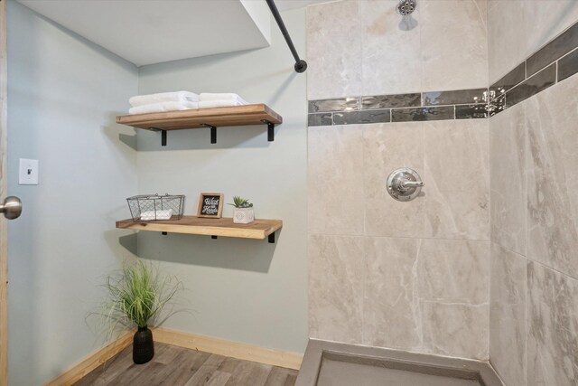 739 Gasper St, Chesaning, MI 48616 - full bath with a tile shower, wood finished floors, and baseboards