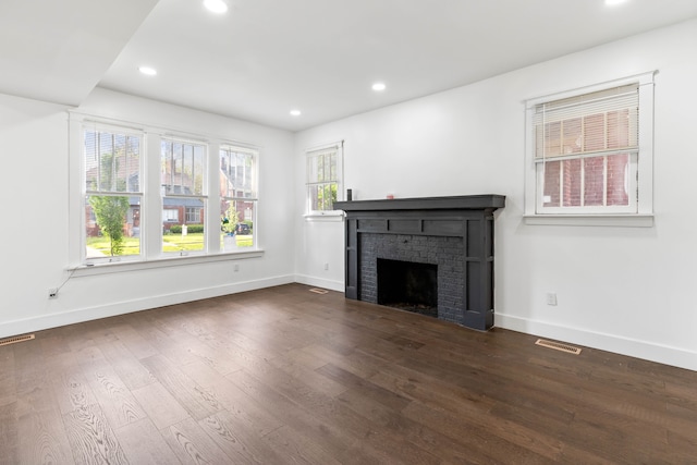 1651 Edison St, Detroit, MI 48206 - unfurnished living room with dark wood-style floors, a brick fireplace, baseboards, and recessed lighting