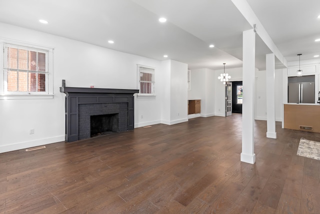 1651 Edison St, Detroit, MI 48206 - unfurnished living room with a fireplace, dark wood-style flooring, baseboards, recessed lighting, and a chandelier