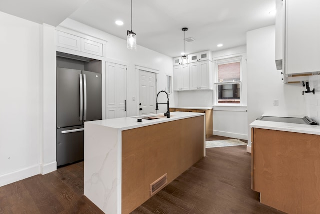 1651 Edison St, Detroit, MI 48206 - kitchen with freestanding refrigerator, a sink, dark wood-type flooring, glass insert cabinets, and a kitchen island with sink