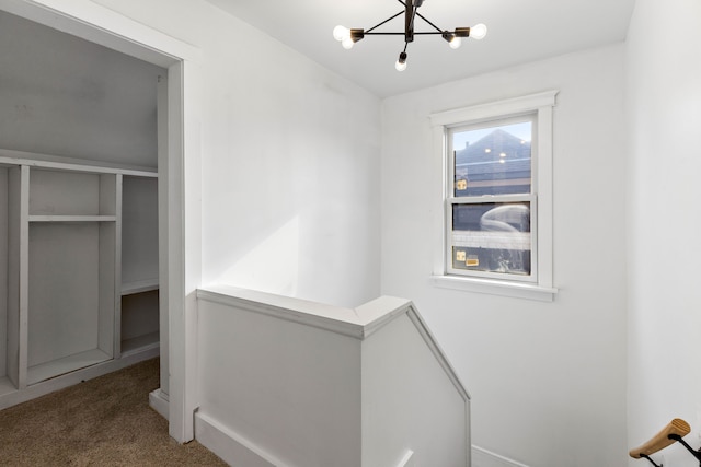 1651 Edison St, Detroit, MI 48206 - hallway featuring an upstairs landing, a chandelier, and carpet flooring