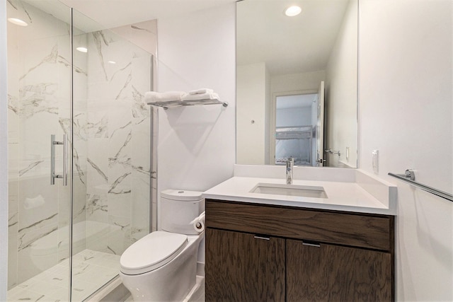 bathroom featuring recessed lighting, a marble finish shower, vanity, and toilet