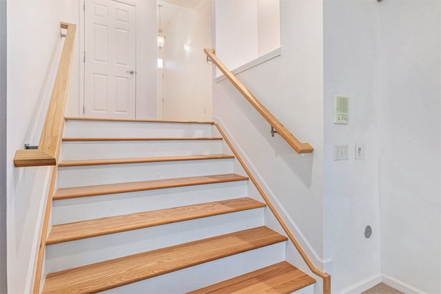 staircase featuring baseboards