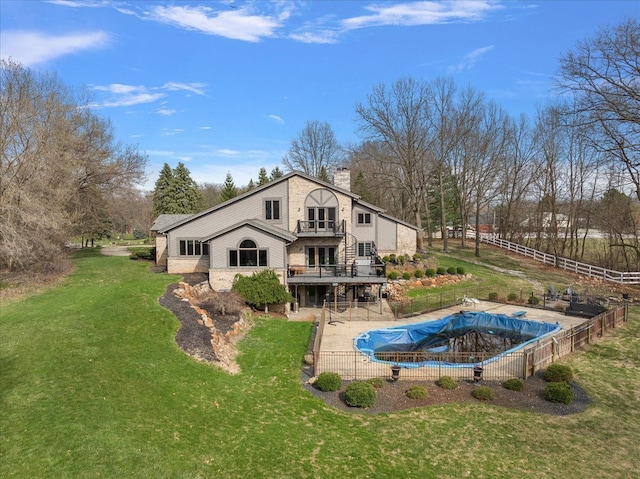 1194 Eagle Nest, Milford, MI 48381 - back of property with a chimney, a balcony, and a patio area
